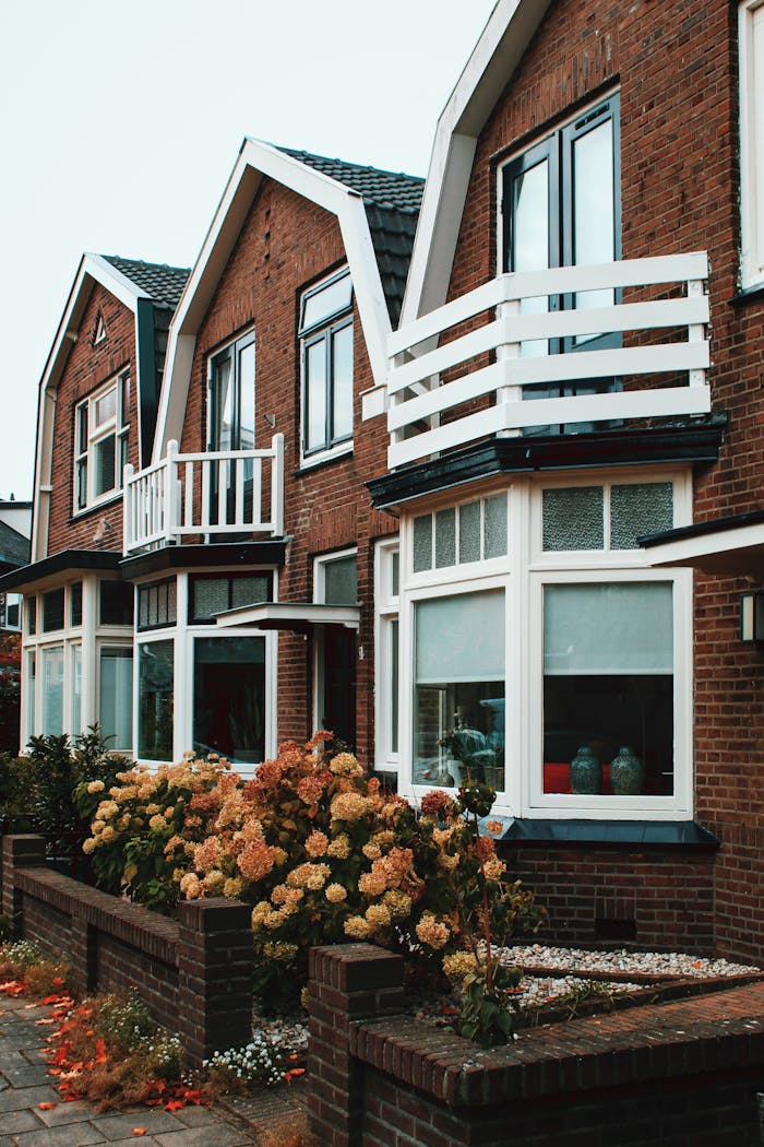 our-experience Charming brick homes in Deventer with white balconies and blooming flowers.