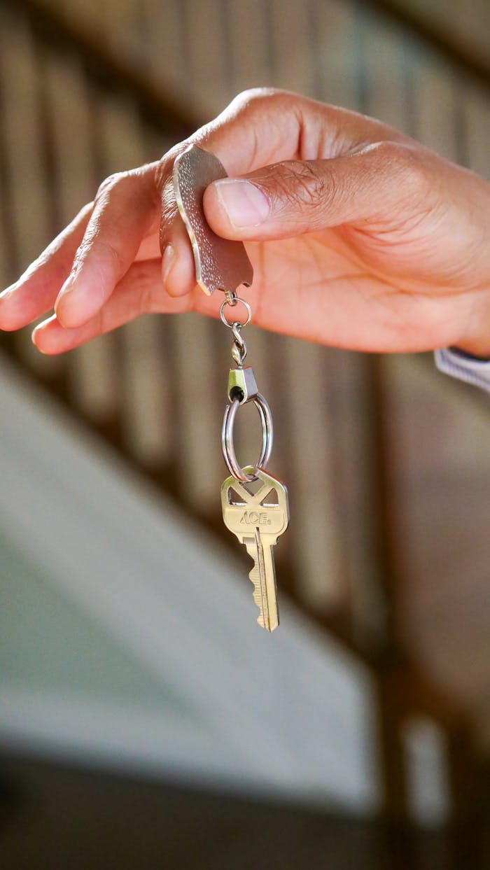 services-03 Close-up of a hand holding a key, symbolizing new homeownership or rental.