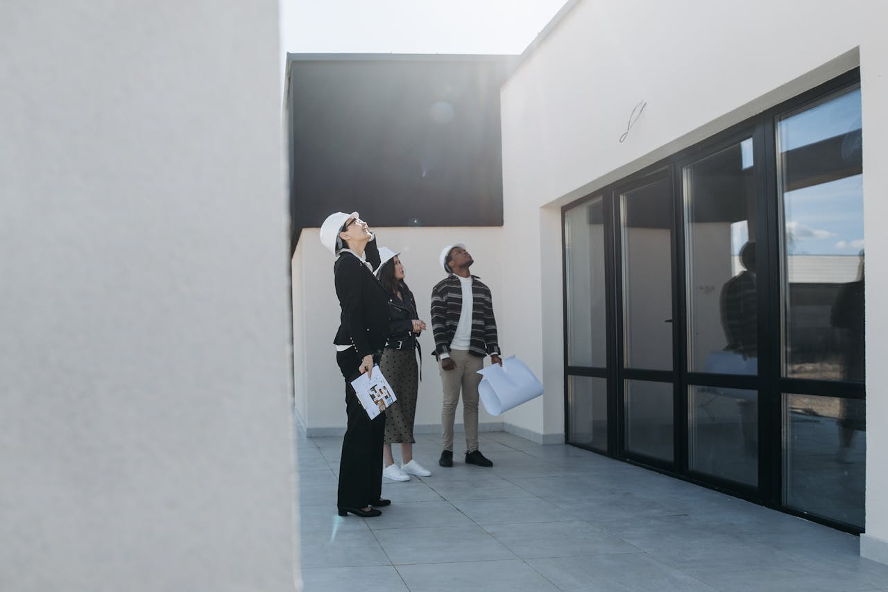 why-choose-us Group of real estate agents assessing a modern building during the day.